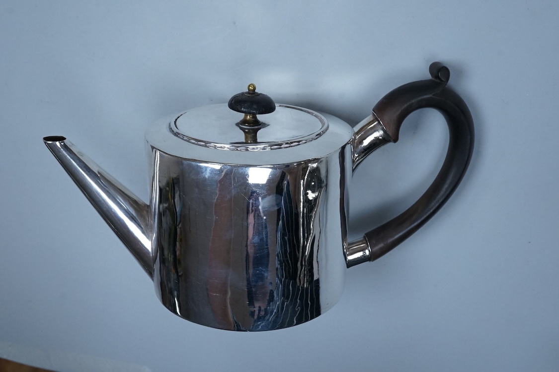 A George III engraved silver oval teapot, makers mark RD?, London, 1794, together with one other Georgian silver teapot with associated silver cover, gross weight 26.8oz.